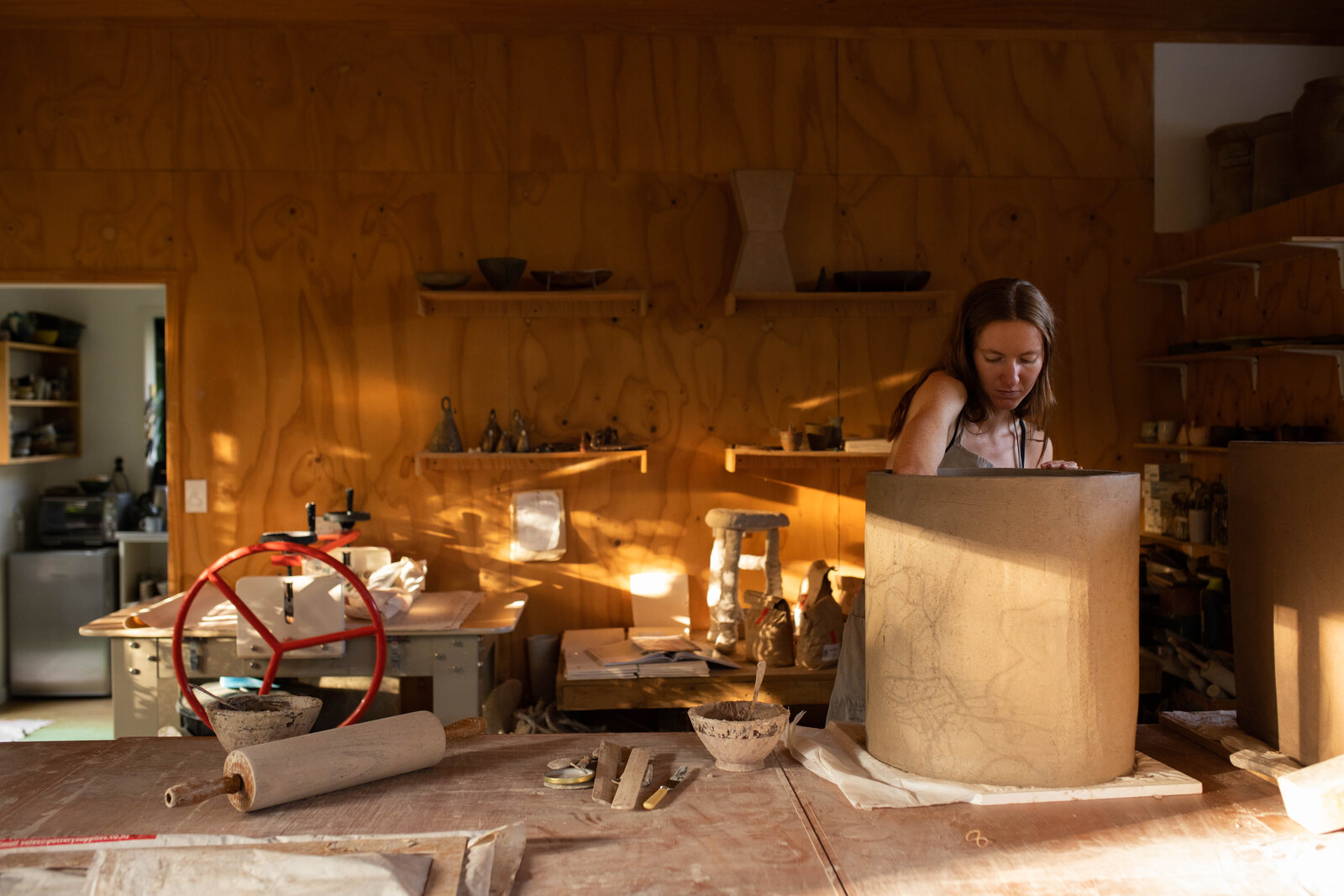 Jaime Jenkins working a large slab form in her studio