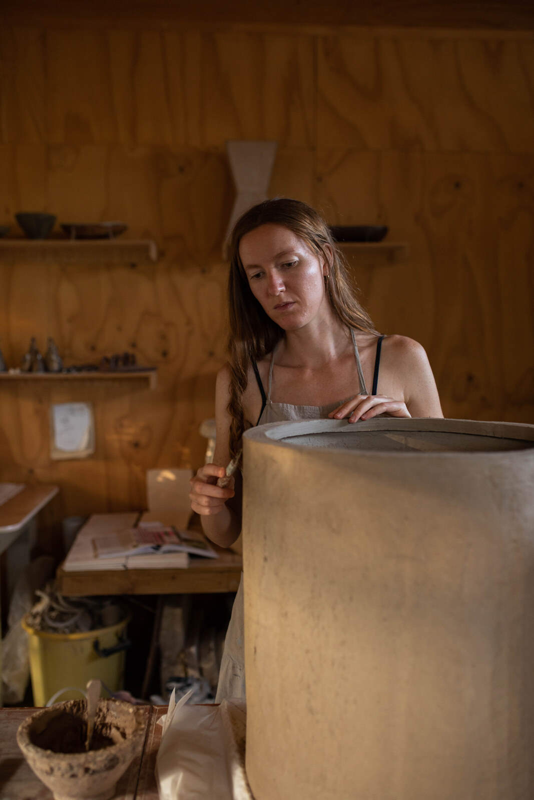 Jaime Jenkins working a large slab form in the studio
